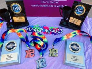 A table displaying medals and plaques from Color Dash 2022